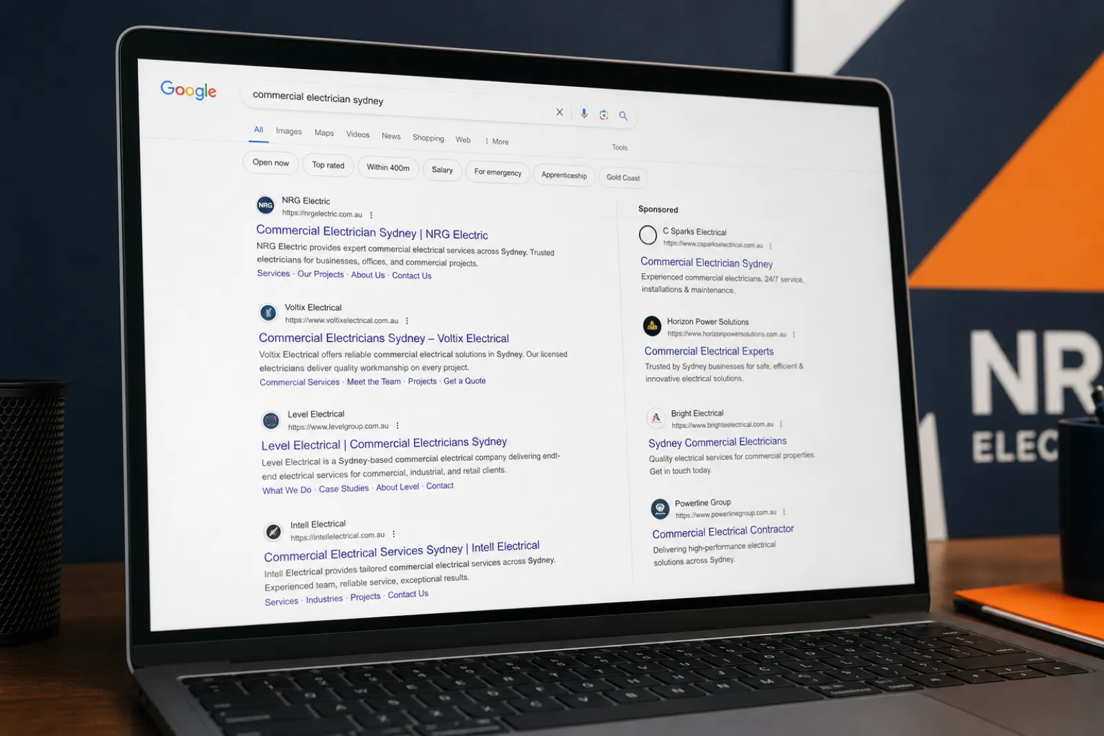 Close-up of a laptop screen showing a Google search results page with organic and sponsored listings